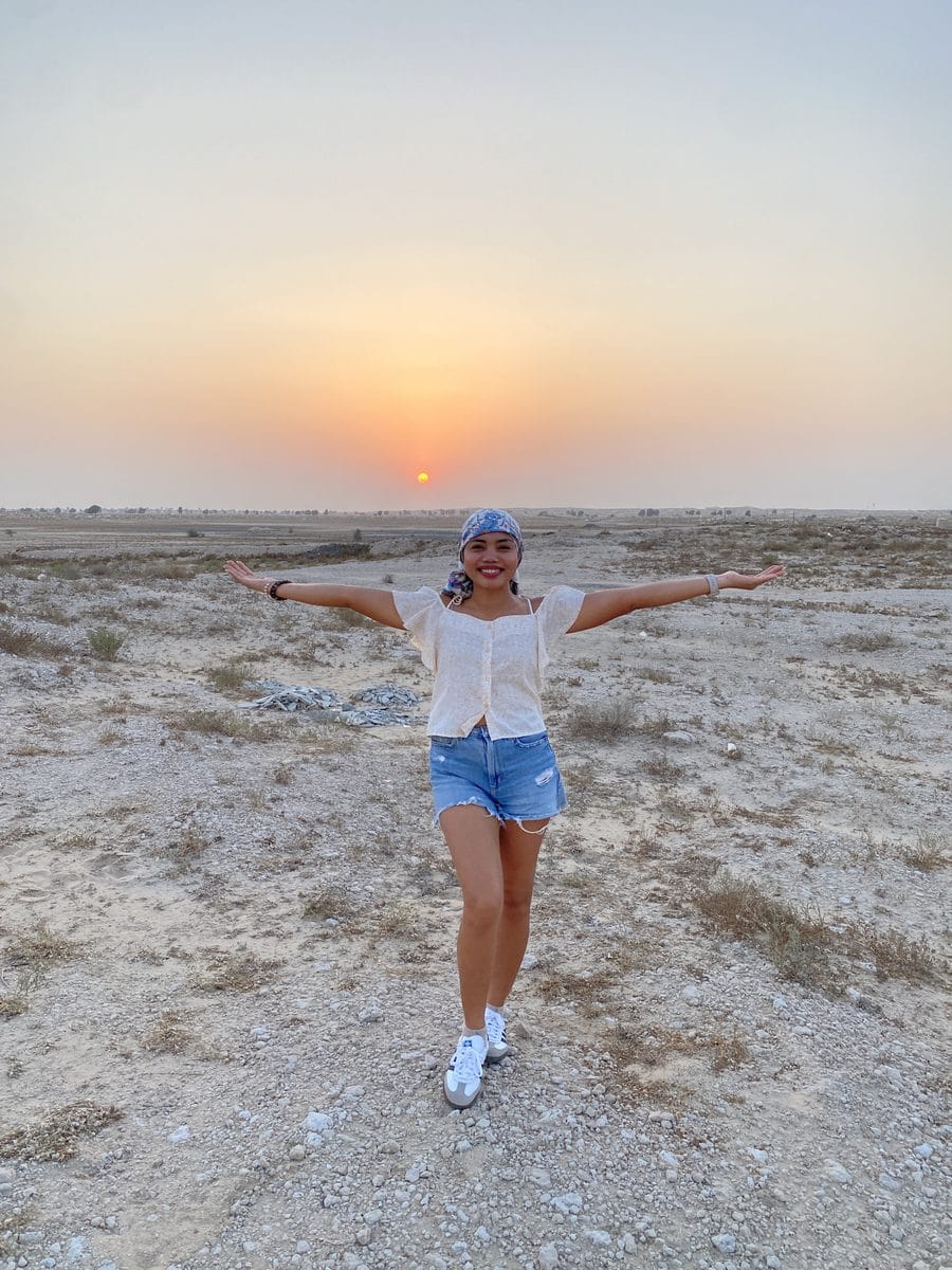 Dopegine enjoying a desert sunset during her travels